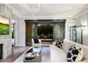 Living room with fireplace, patio access, and modern decor at 7175 E Camelback Rd # 107, Scottsdale, AZ 85251