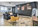 Living room with dark walls, comfy seating, and movie theme at 5837 N 89Th Dr, Glendale, AZ 85305