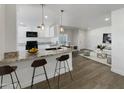 Open concept kitchen with granite countertops and island at 2711 N Olympic Cir, Mesa, AZ 85215
