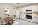 Cozy kitchen featuring white cabinets and a breakfast nook at 14300 W Bell Rd # 35, Surprise, AZ 85374