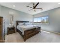 Spacious bedroom with a wooden bed frame and large windows at 7347 E Casitas Del Rio Dr, Scottsdale, AZ 85255