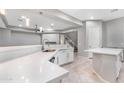 Modern kitchen with white cabinets and a large island at 32029 N 20Th Ln, Phoenix, AZ 85085