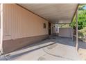 Covered carport area next to a manufactured home, with a storage shed at 2650 W Union Hills Dr # 236, Phoenix, AZ 85027