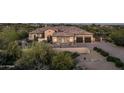 Stunning Spanish-style home with a tile roof, stone accents, and a three-car garage at 36495 N Livorno Way, Scottsdale, AZ 85262
