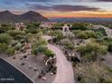 Gated entrance to a luxury estate with long driveway at 23036 N Via Ventosa Dr, Scottsdale, AZ 85255