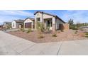 Charming house with attractive landscaping and a welcoming porch at 702 E Coho Dr, San Tan Valley, AZ 85140