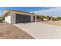 View of the home's front facade, driveway, and landscaping at 12432 W Spring Ridge Dr, Sun City West, AZ 85375