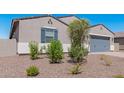 New construction home with gray garage and desert landscaping at 3454 E Jasmine Way, San Tan Valley, AZ 85143