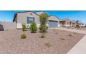New construction home with gray garage door and desert landscaping at 3454 E Jasmine Way, San Tan Valley, AZ 85143
