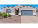 Modern two-story home with gray garage door and landscaping at 3454 E Jasmine Way, San Tan Valley, AZ 85143