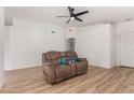 Living room with brown recliner and light wood floors at 4545 N 67Th Ave # 1242, Phoenix, AZ 85033