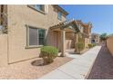 Tan two-story house with a walkway and neatly landscaped yard at 812 E Agua Fria Ln, Avondale, AZ 85323