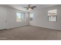 Spacious living room with carpet flooring, neutral walls, and large windows at 812 E Agua Fria Ln, Avondale, AZ 85323