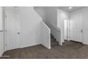 Bright, open entryway with carpeted staircase and flooring at 851 E Agua Fria Ln, Avondale, AZ 85323