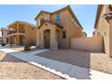 Two-story house with light brown exterior, walkway, and small front yard at 851 E Agua Fria Ln, Avondale, AZ 85323