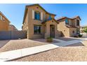 Two-story house with light brown exterior, walkway, and small front yard at 851 E Agua Fria Ln, Avondale, AZ 85323