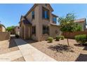 Two-story house with stone accents and desert landscaping at 927 E Agua Fria Ln, Avondale, AZ 85323