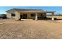 Covered patio, firepit, and spacious backyard with gravel landscaping at 1527 E Germann Rd, San Tan Valley, AZ 85140