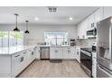 Modern kitchen with white cabinets, stainless steel appliances, and quartz countertops at 2616 S Extension Rd, Mesa, AZ 85210