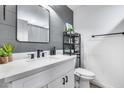Stylish bathroom with gray shiplap walls, modern vanity, and quartz countertop at 2616 S Extension Rd, Mesa, AZ 85210