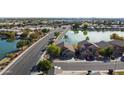 Aerial view of house near lake in residential area at 10801 W Palm Ln, Avondale, AZ 85392