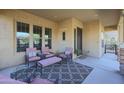 Relaxing front porch featuring comfortable seating and a patterned rug at 20377 W Terrace Ln, Buckeye, AZ 85396