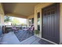 Inviting front porch with comfortable seating and a decorative rug at 20377 W Terrace Ln, Buckeye, AZ 85396