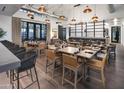 Modern community dining area with wood floors and copper light fixtures at 11268 N Williamsburg Ave, Surprise, AZ 85388