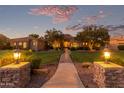 Luxury home with stone accents and landscaped yard at dusk at 2068 E Tiffany Ct, Gilbert, AZ 85298