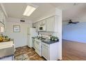 Galley-style kitchen with white cabinets and tiled floor at 10418 N 97Th Dr # B, Peoria, AZ 85345