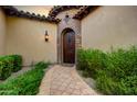 Elegant entryway with a curved walkway and arched doorway at 3248 S Golden Barrel Ct, Gold Canyon, AZ 85118