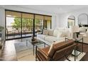 Bright living room with balcony access and modern furniture at 7175 E Camelback Rd # 202, Scottsdale, AZ 85251