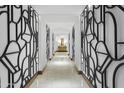 Elegant hallway with unique geometric wall art at 7175 E Camelback Rd # 202, Scottsdale, AZ 85251