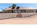 Brick house with a brown metal roof and staircase at 33325 W Old Us Highway 80 Hwy, Arlington, AZ 85322