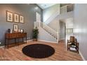 Living room with high ceilings, wood floors, and staircase at 42331 W Somerset Dr, Maricopa, AZ 85138