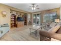 Living room with tiled floors, wood shelving, and comfortable seating at 43154 N Outer Banks Dr, Anthem, AZ 85086