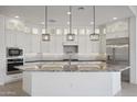Modern kitchen with white cabinets, granite countertops, and stainless steel appliances at 13190 W Horsetail Trl, Peoria, AZ 85383