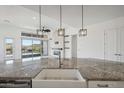 Modern kitchen island with farmhouse sink and stainless steel appliances at 13190 W Horsetail Trl, Peoria, AZ 85383