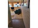 Hallway with tile flooring and exposed brick at 815 N Hayden Rd # D201, Scottsdale, AZ 85257