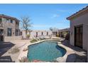 Inviting kidney-shaped pool with a surrounding patio and landscaping at 8876 S Santa Elizabeth Dr, Goodyear, AZ 85338