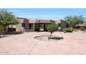 House exterior with a circular driveway and desert landscaping at 8876 S Santa Elizabeth Dr, Goodyear, AZ 85338