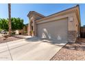 Tan house with a single-car garage and a tree at 3122 E Windmere Dr, Phoenix, AZ 85048