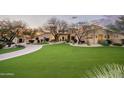 Luxury home with manicured lawn and paver driveway at 24546 N 91St St, Scottsdale, AZ 85255