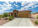 Single story home with a two-car garage and desert landscaping at 4498 N Petersburg Dr, Florence, AZ 85132