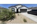 Single-story home with gray garage door at 2114 S 241St Ave, Buckeye, AZ 85326