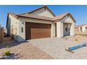 New construction home with brown garage door and stone accents at 21354 E Sparrow Dr, Queen Creek, AZ 85142