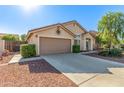 One-story house with a two-car garage and attractive landscaping at 10413 W Ashbrook Pl, Avondale, AZ 85392