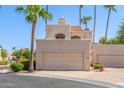 Two-story stucco home with attached garage and desert landscaping at 1301 W Coral Reef Dr, Gilbert, AZ 85233