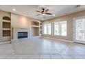 Spacious living room with tile floors, fireplace, and built-ins at 17724 W Ocotillo Ave, Goodyear, AZ 85338