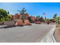 Community entrance with flag and signage at 4303 E Cactus Rd # 441, Phoenix, AZ 85032